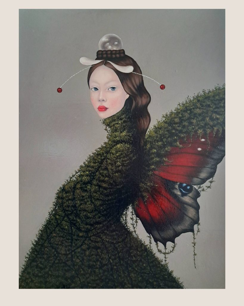 "Surreal portrait painting of a woman with traditional Asian hair styling and ornamental accessories, whose lower body seamlessly transforms into dense green foliage and moss-like texture. A large red and black butterfly with striking blue eye spots emerges from the verdant growth. The subject has pale skin, red lips, and wears decorative hair pins with dangling red beads. The artwork is rendered in realistic detail against a muted gray background, creating a dreamlike fusion of human form and natural elements.