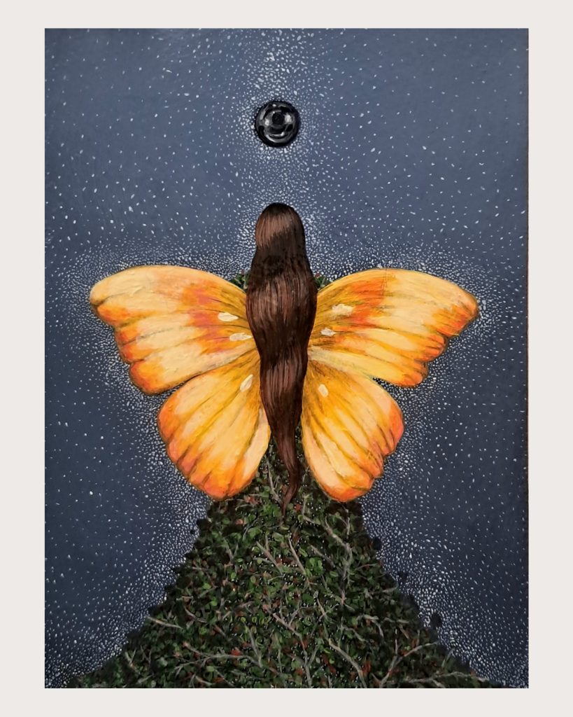 Surreal artwork depicting a figure with long brown hair viewed from behind, whose body transforms into a large orange and yellow butterfly with outstretched wings. The lower portion of the figure becomes dense green foliage and botanical elements. Above, a dark celestial orb hovers in a starry night sky filled with white dots resembling stars or snow against a deep blue-gray background. The composition creates a mystical fusion of human form, nature, and cosmic elements.